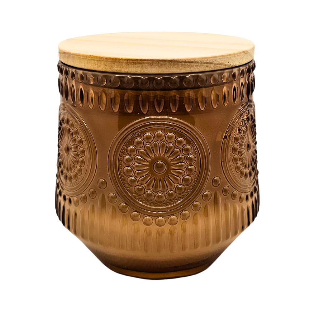 Decorative brown ceramic stool with intricate patterns on a white background